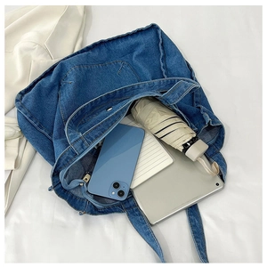 Interior view of denim tote bag showing capacity for tablet, umbrella and notebook