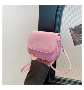 Detailed shot of pink crossbody saddle bag with adjustable strap and Fashion Trend logo