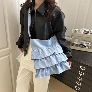 Light blue tiered ruffle tote bag featuring a pleated design and wide canvas shoulder strap