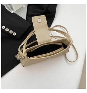 Detail showing the champagne gold textured interior with black fabric lining and zipper pocket