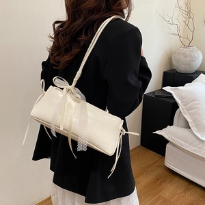 Minimalist cream rectangular shoulder bag with lace bow detail and slim strap for women