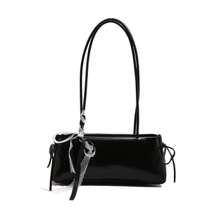 Minimalist black rectangle underarm bag with glossy finish and white lace bow detail