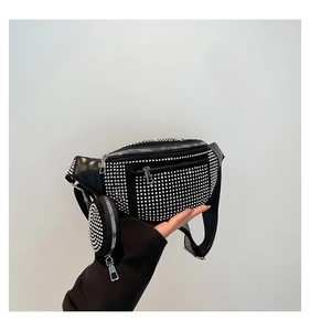 Detail of black rhinestone fanny pack with wide strap and mini round pouch attachment