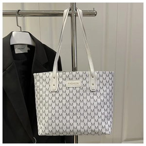 Detail of white tote bag with M-pattern print and Fashion label on double straps