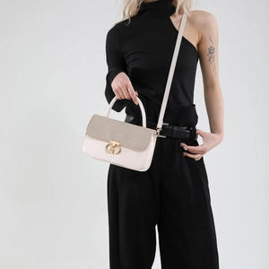 Chic cream leather handbag with brown woven flap and golden CH buckle on model