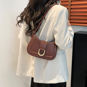 Minimalist brown underarm bag with gold U-shaped buckle for casual everyday wear