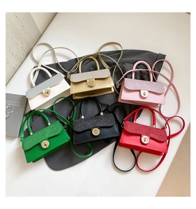 Detailed flat lay of mini crossbody bags in six vibrant colors with glitter flap detail