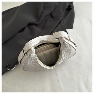 Detail of white woven crescent bag with matching pouch and silver strap buckle