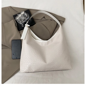 Close-up of woven texture and decorative fashion tag on a cream large tote bag
