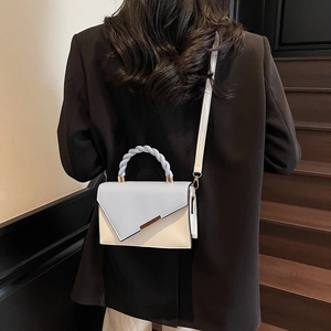 Contrast color crossbody bag in light blue and beige with geometric flap and woven handle