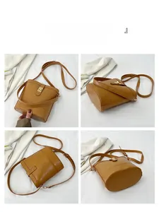 Detail view of vintage brown bucket bag with gold lock closure and textured leather
