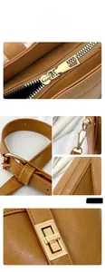 Detailed macro view of gold-tone hardware, lychee texture leather, and neat stitching