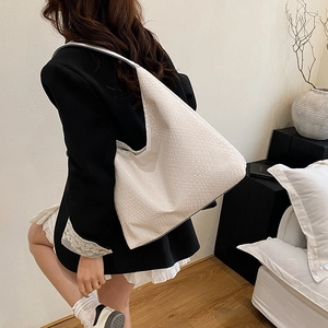 Minimalist beige woven leather hobo bag with large capacity shown on model