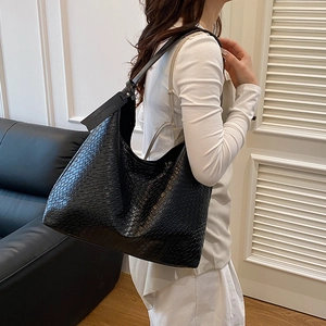 Minimalist black woven leather tote bag with large capacity and stylish shoulder strap