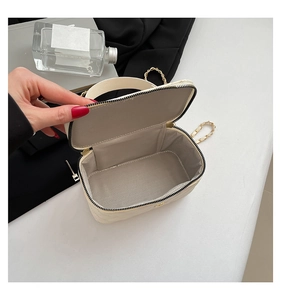 Top view of open beige box bag showing grey twill lining and spacious interior