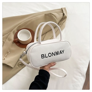Detailed view of white woven texture handbag with BLONMAY print and detachable strap