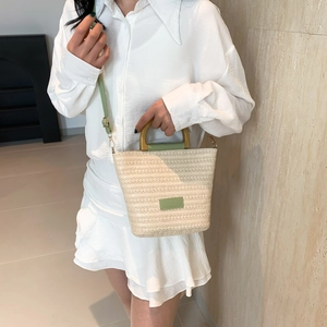 Fashionable straw bucket bag with green leather trim and wooden handles for women