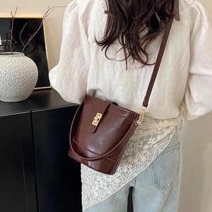 Retro dark brown leather bucket tote bag with gold buckle for 2025 spring summer collection