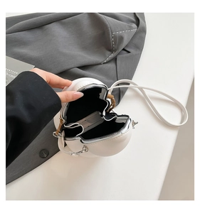 Macro view of white leather gourd bag showing black fabric lining and zipper closure