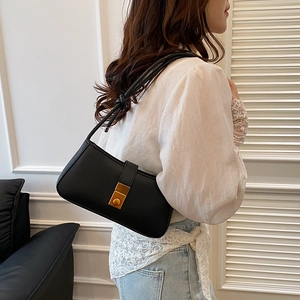 Minimalist black faux leather shoulder bag with vintage gold buckle and knotted strap