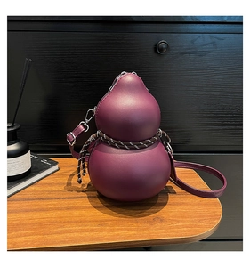 Detail of dark purple gourd-shaped crossbody bag with decorative woven rope and silver buckle