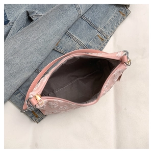 Top view of pink floral jacquard shoulder bag showing zipper closure and interior lining