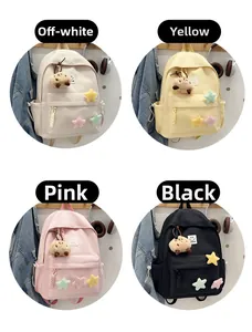 Macro display of four pastel school backpacks with cute plush star patches and charms
