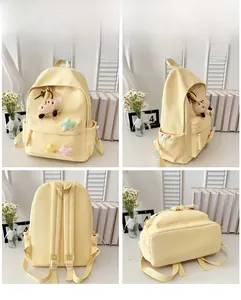 Four-angle view of a light yellow canvas school backpack with star patches and plush charm