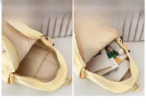 Interior view showing the large capacity and storage pocket of the yellow nylon backpack