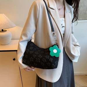 Minimalist black floral underarm bag with silver chain and green flower charm