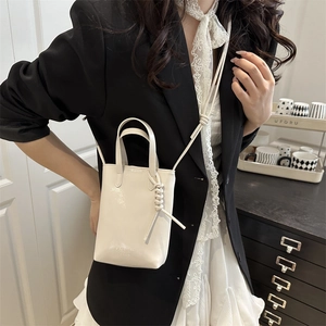 Chic beige leather vertical mini crossbody phone bag with knot strap detail