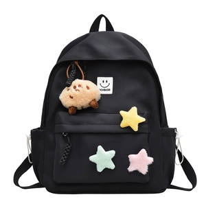 Black school backpack with colorful plush stars, DOXBAGS label, and brown animal charm