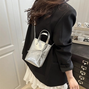 Mini silver metallic pleated crossbody bag with top handle and fashion text detail