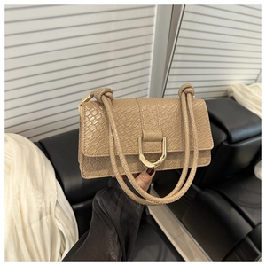 Detail of khaki woven texture handbag with golden U-shaped buckle and knot shoulder strap