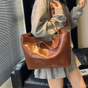 Minimalist brown faux leather tote bag with long straps for stylish women's daily commuting