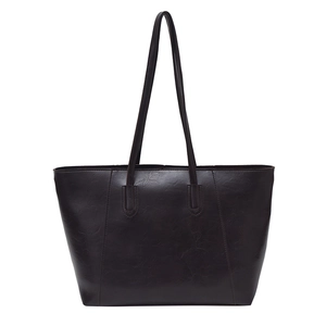 Minimalist large brown tote bag with vintage leather texture and slim shoulder straps