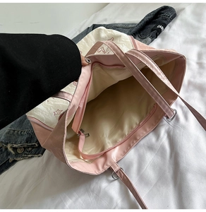 Detail view of pink and white tote bag interior with zipper pocket and large capacity