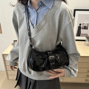 Black glossy patent leather crescent shoulder bag with vintage silver buckle strap