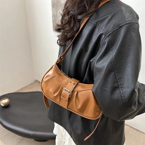 Retro brown glossy underarm bag with pleated design and metal buckle detail for women