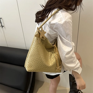 Minimalist woven faux leather tote bag with star charms and drawstring in ginger yellow