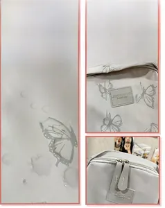 Waterproof fabric detail of butterfly backpack showing water beads and metal zippers