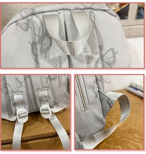 Detail view of butterfly print backpack showing top handle and adjustable straps