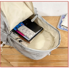 Interior view of the grey butterfly backpack showing spacious storage for gadgets