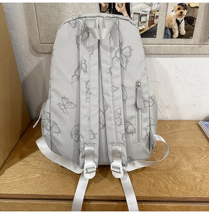 Close-up of padded shoulder straps and rear anti-theft zipper on butterfly print backpack
