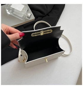Interior view of white PU leather crossbody bag showing internal space and golden buckle