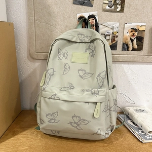 Macro detail of butterfly print on lightweight mint green backpack with zippered pocket