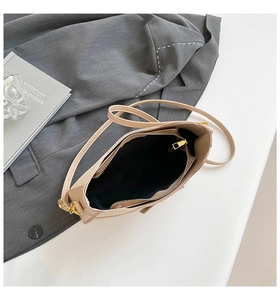 Top view of beige chic shoulder bag featuring light gold metal zipper and fabric lining