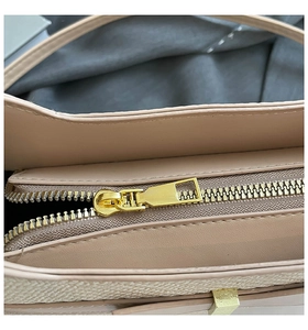 Close-up of golden metal zipper and premium leather texture on stylish handbag