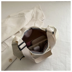 Interior view of cream tote bag showing capacity for phone, wallet and accessories