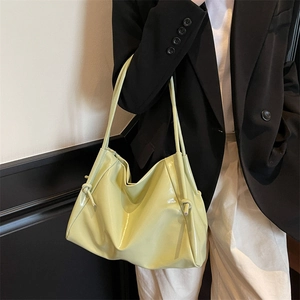 Minimalist light green glossy shoulder bag in a crescent shape for elegant daily styling